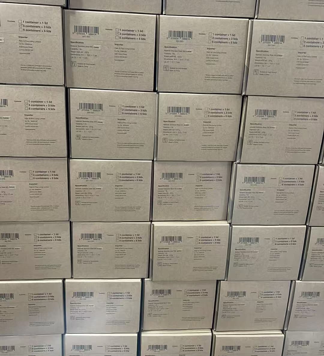 Hundreds of boxed Loopware founding-batch sets stacked and labelled in the warehouse, ready to ship to the UK.